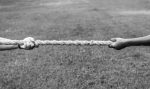 Tug of war, two arms pulling a rope